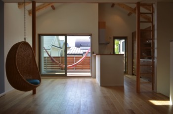  View of the dining and kitchen area with hanging chair. 